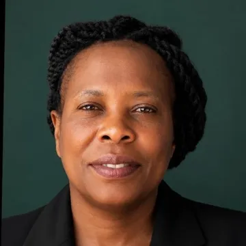 Rachel Kwamboka Nyakwara, photographed against a dark green background.